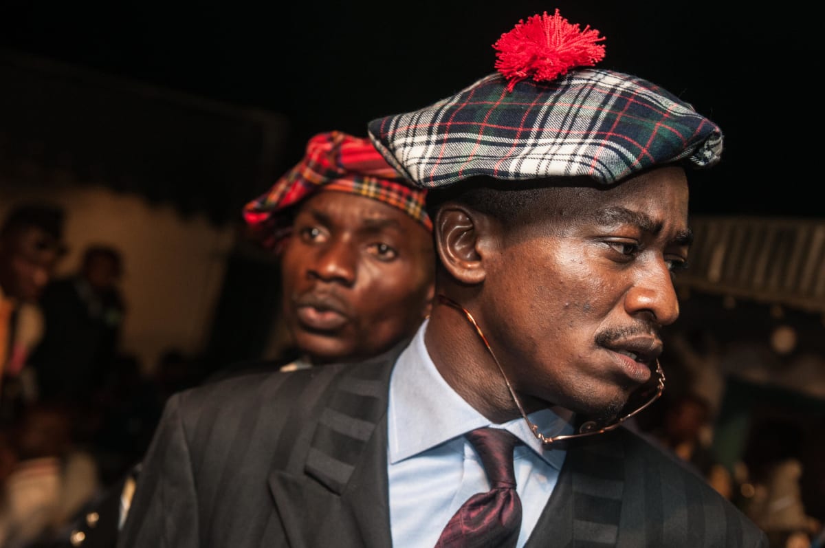 Untitled  Image: Close up photograph of two members of the Piccadilly Group, around the city at nighttime. Brazzaville, Congo (2008)