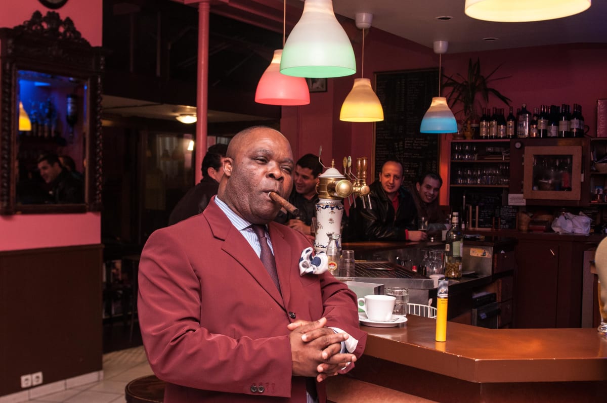 Untitled  Image: A Sapeur client of 'Connivences', a Congolese tailor boutique in Paris, at a bar. Paris, France (2008)