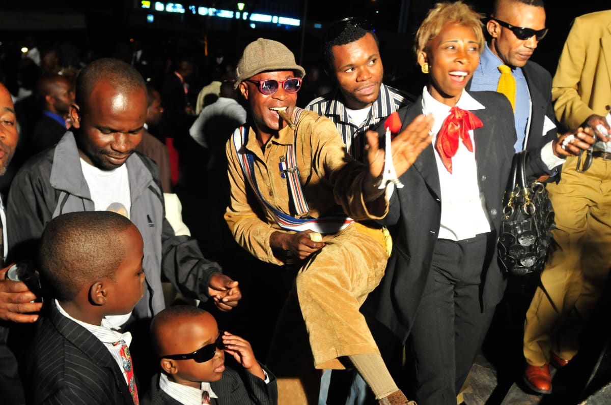 Untitled  Image: Group of Sapeurs posing for the cameras at a night club, with the central Sapeur holding a reproduction of the Tourre Eiffel. Brazzaville, Congo (2008)