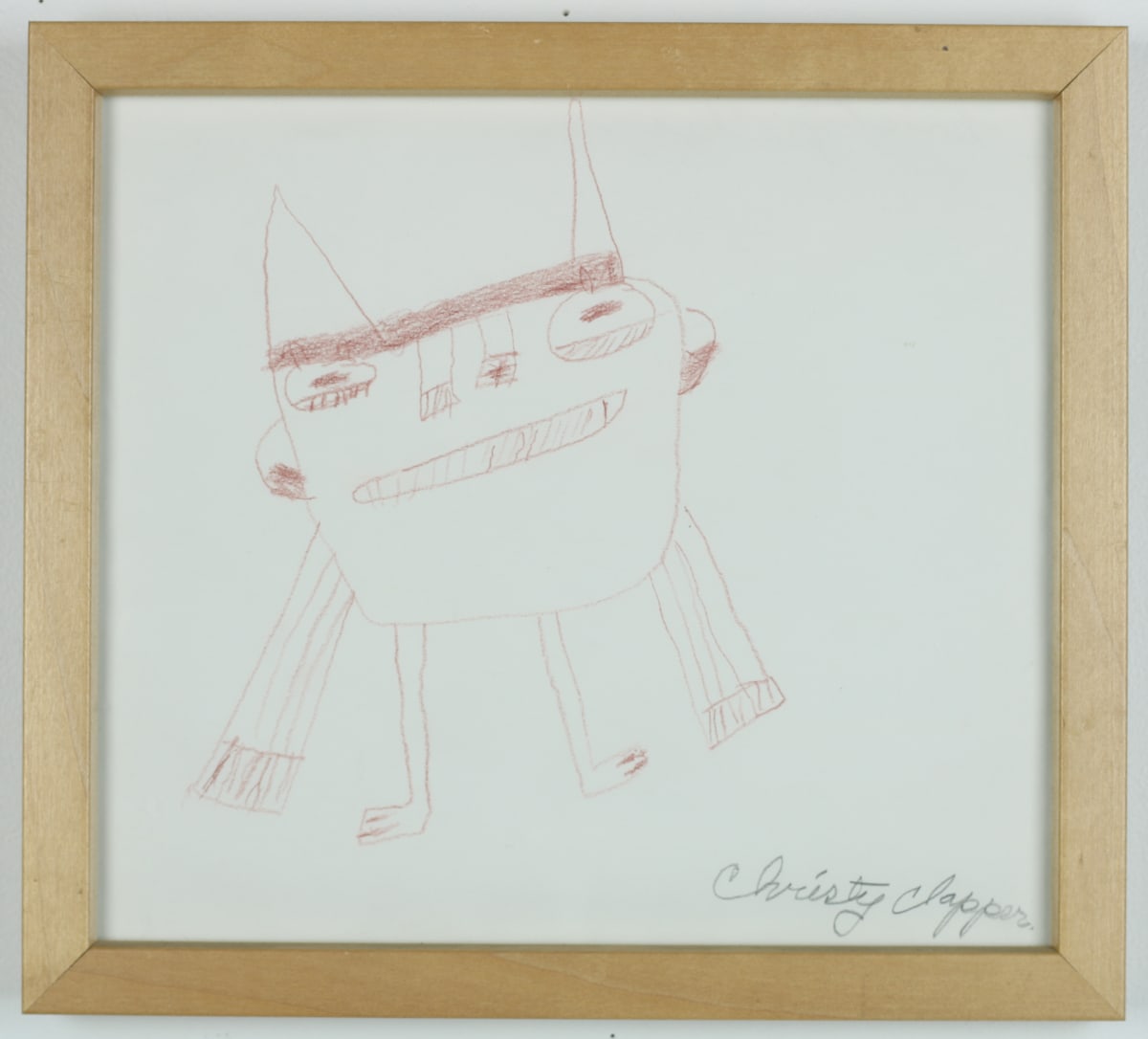 Untitled by Christy Clapper  Image: Brown pencil drawing of a smiling figure with arms and legs. 