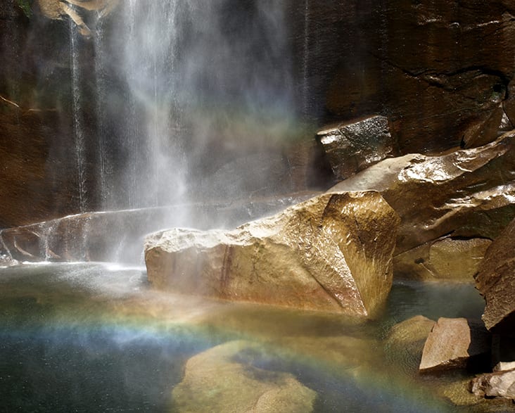 Light Filled Waterfall Mist with Rainbow by Donald Hill 