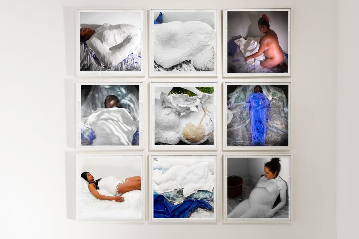 Fissure (Linea Negra series) Polyptych by Coralina Rodriguez Meyer  Image: The Fissured suite of photographs are a polyptych altarpiece (9 photographs) from the Linea Negra series. Depicting the Mama Spa Botanica workshop where the artist collaborates with black and brown pregnant people who cast their pregnant bodies in vernacular Mother Mold belly casts, the work and process illuminate reproductive health care structures. Installed in a quadratic tile arrangement, the photographs contrast the architectural fissures of dropped ceiling tiles seen in forensic hospital settings to the material consistency of plaster on skin. Shot in domestic settings where home births typically occur, the photographs document agency building workshops. Medically described, a fissure is an anatomical cleft or tear often associated with trauma during pregnancy and result in visual "stretchmarks" on the skin. Architecturally, a fissure is the texture most commonly applied to asbestos drop ceiling tiles found in institutional settings including hospitals- often the last image a black or brown mother will see before delivering her child.

The Linea Negra series photographs (2008-present) documents the inception of gender, power and race structures from slogans, slang, maxims and "old wives tales" to internalized, institutional violence. The works celebrate the melanin line appearing during gestation (most prominent in women of color) as a biological pieta; the first biographical mark on the procreative body and the first sign of our creative humanity.