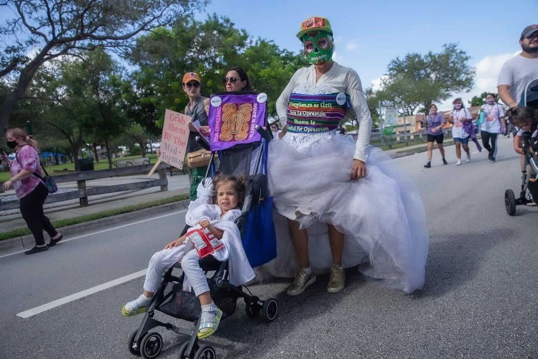 Arpillera Americanx * Cunt Quilt (Paso) Cunt Congress by Coralina Rodriguez Meyer  Image: Performance of Citizenship by artist Coralina Rodriguez Meyer & her daughter at Reproductive Justice March Miami FL October 2, 2021 Photo by Jonathan des Camps
