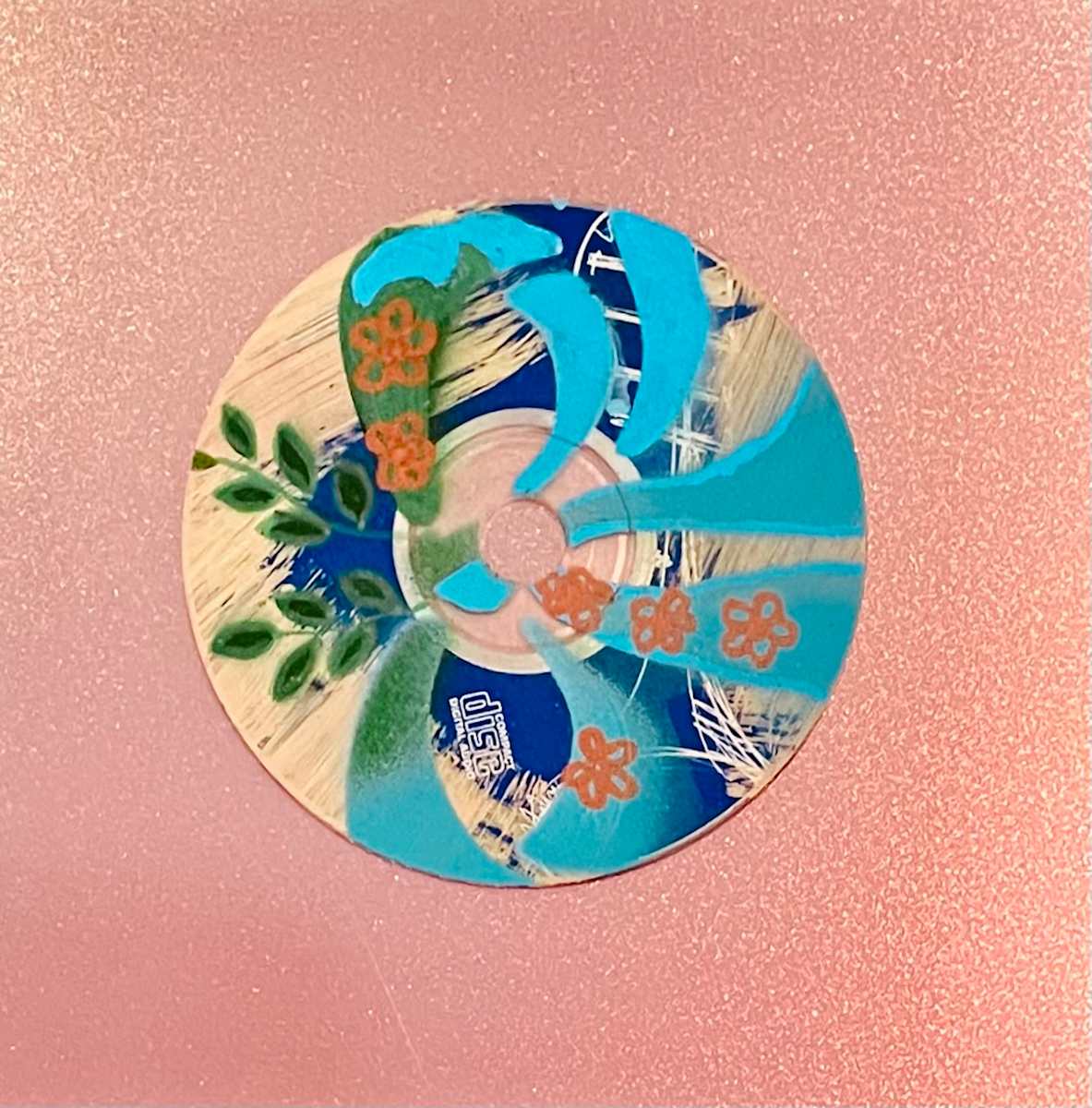 Botanical Collage by Dr. Vasundhara (Vasu) Tolia  Image: A layered mixed-media piece combining natural botanical
elements with decorative patterns in blues and greens, featuring floral motifs and
organic textures in a contemporary assemblage style.