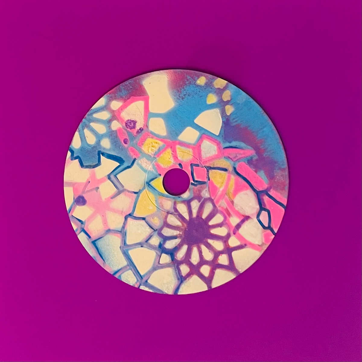 Fragmented Dreams by Dr. Vasundhara (Vasu) Tolia  Image: A layered composition combining geometric patterns
with organic forms in blues, purples, and pinks, featuring mandala elements overlaid
with abstract shapes and flowing lines.