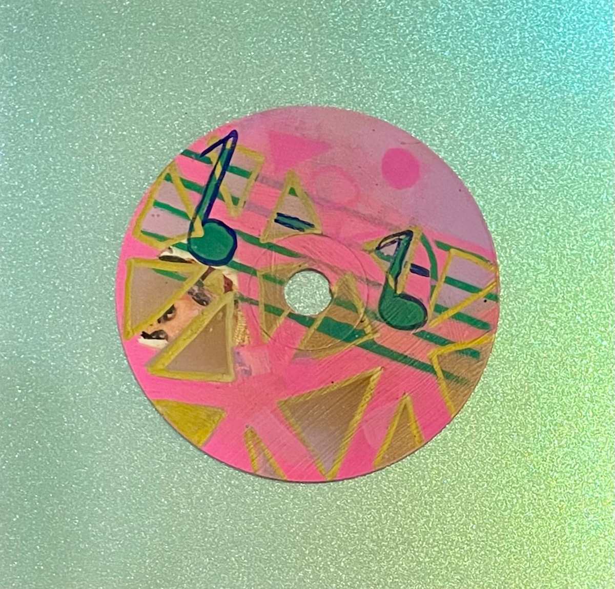 Musical Geometry by Dr. Vasundhara (Vasu) Tolia  Image: A contemporary mixed-media piece combining musical
notes with geometric triangular forms in pink and gold, creating a harmonious blend of
sound and visual rhythm.