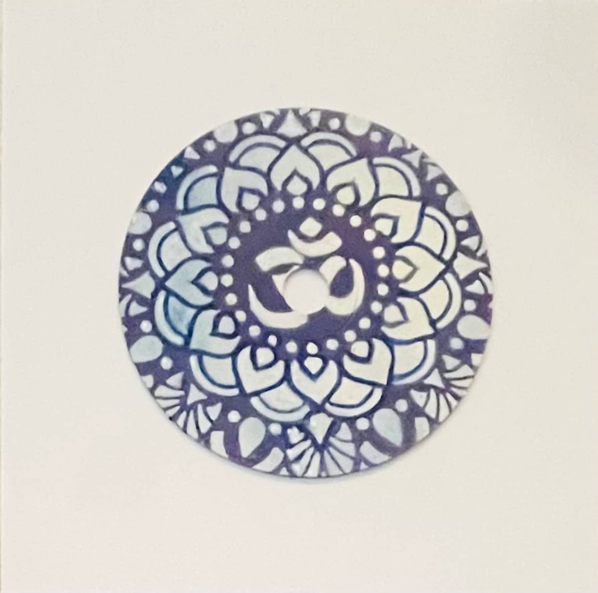 Sacred Geometry by Dr. Vasundhara (Vasu) Tolia  Image: A sophisticated mandala design in navy blue and white
featuring lotus petals surrounding an Om symbol, with intricate dotwork and geometric
patterns radiating from the center.