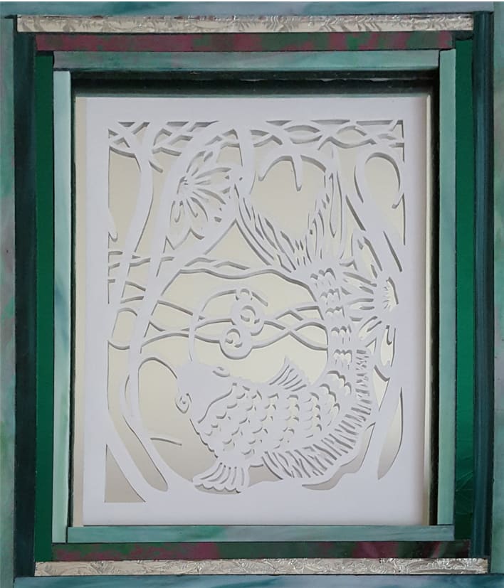 Koi In Mirror by Donna Gonzalez  Image: White Koi paper cut inset in a mirror and framed in a glass frame.