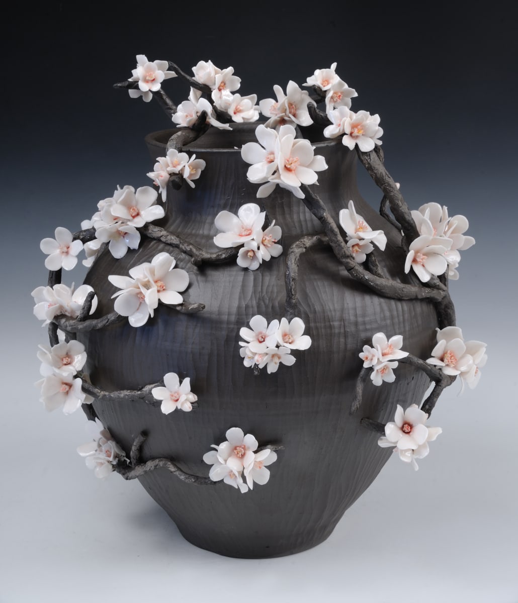 Resilient by Christy Boltersdorf  Image: Black vines encircling black stoneware vase with porcelain cherry blossoms emerging from the vines.