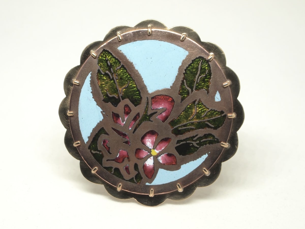 Apple Blossom 6 by Matthew Coté  Image: Design of apple blossom created using champleve enameling technique, with a design of an apple on the back of piece. A study meant to explore the technique of working with enamel glass on metal.