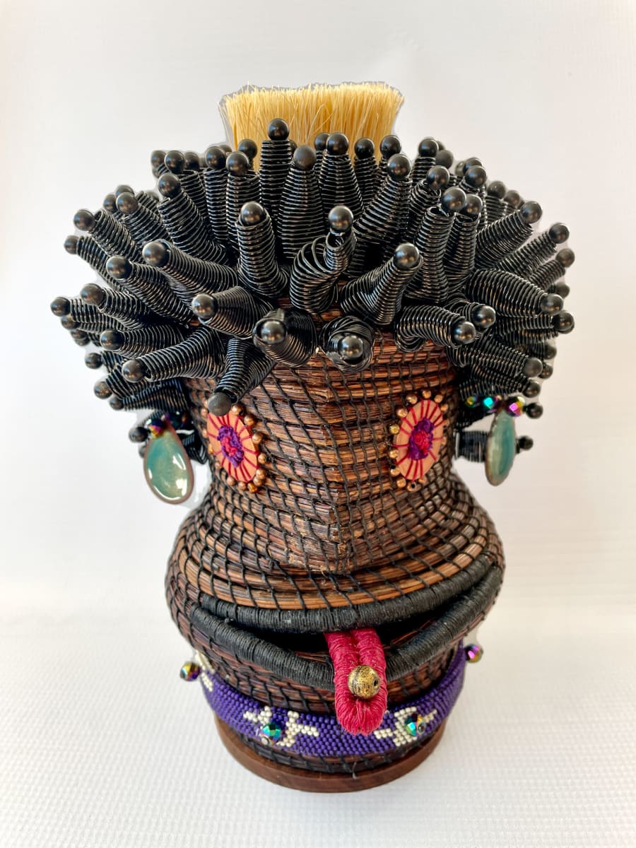 Persisting With Attitude by Jean Koon  Image: "Pine needles coiled w/linen thread. Hair - wire coiled cones pinned to armature, tongue - pine needle coil wrapped with thread.  Eyes - repurposed washers, ear pieces - artist enameled copper.
Neckpiece - beads sewn w/peyote stitch"