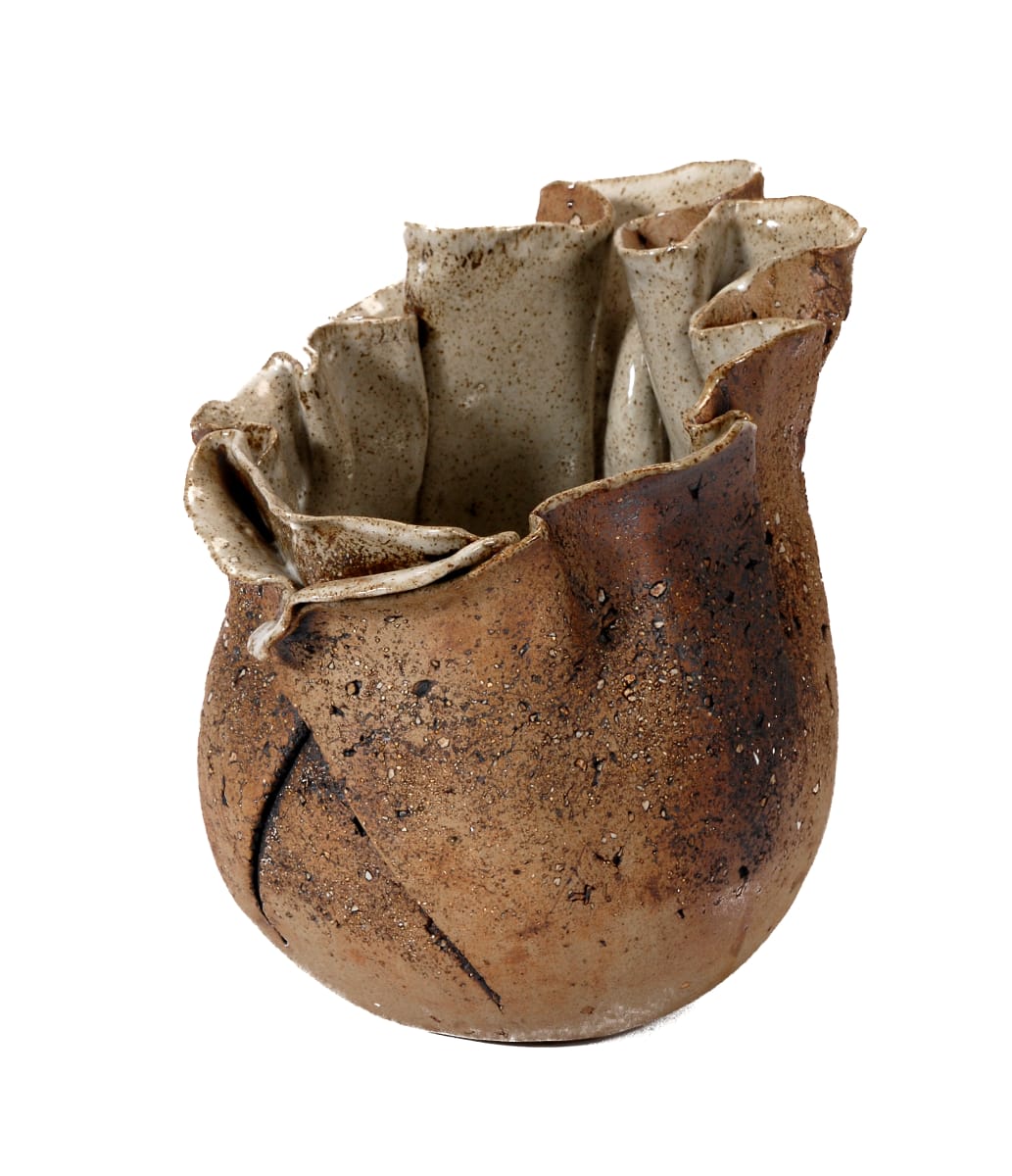 Puff Pot by Bonnie Adams  Image: This is one of a series of Puff Pots created in the mid 90’s. The inspiration comes from the puff ball mushroom. Through its life cycle it experiences stages of growth, tension and finally explosion to release its fruit (spores). This open vessel suggests the offering of its fruit. Hand-built pottery was always more exciting to me than wheel thrown. I always enjoy the challenge of controlling unregulated movement and intentions of the clay.