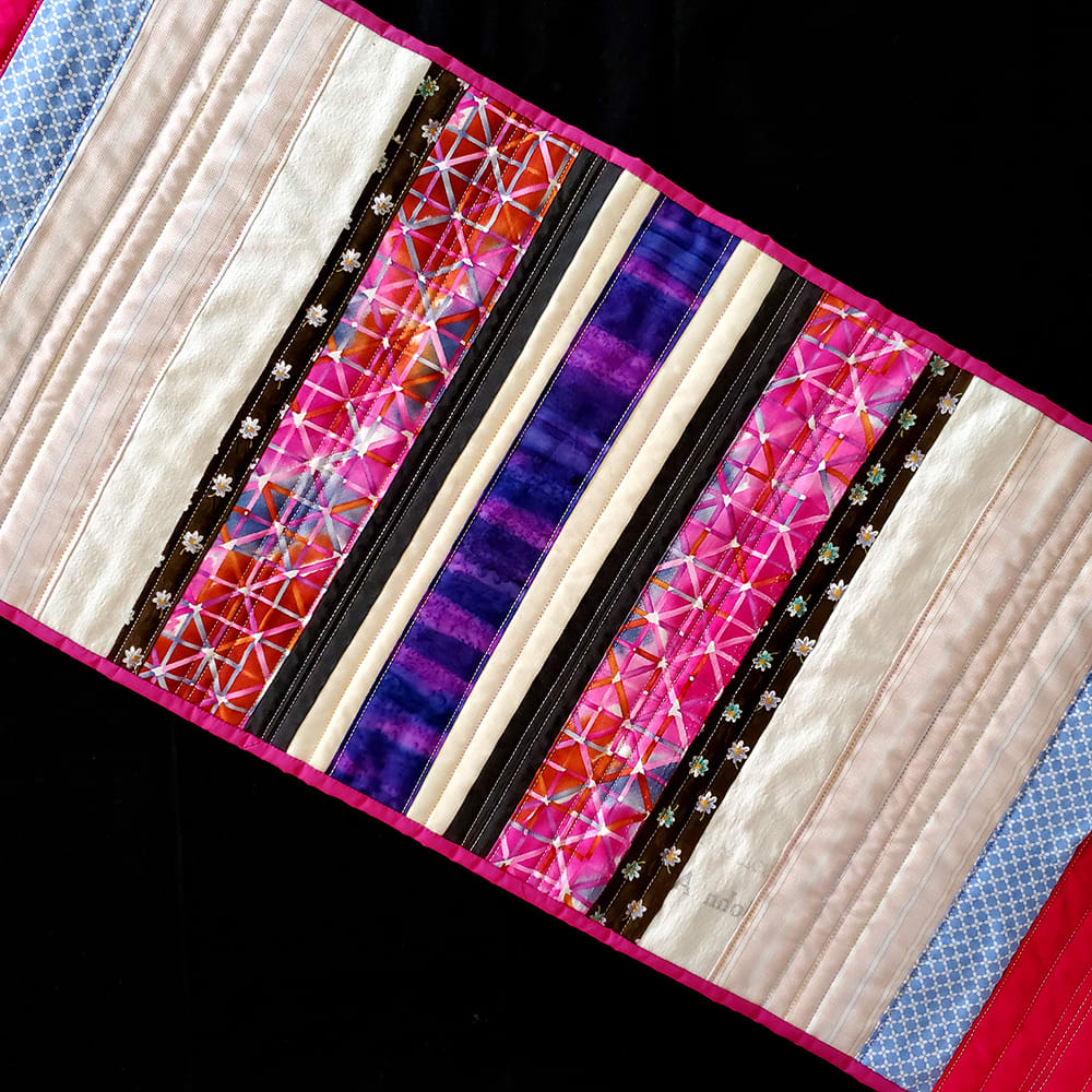 SYNESTHESIA Table Runner: Fuchsia 1  Image: SYNESTHESIA Table Runner: Fuchsia 1
Reclaimed garments and other fabrics, machine pieced and quilted
15"w x 48"h
Created for Factory Obscura's SYNESTHESIA installation at the Fred Jones Jr. Museum of Art, 2022