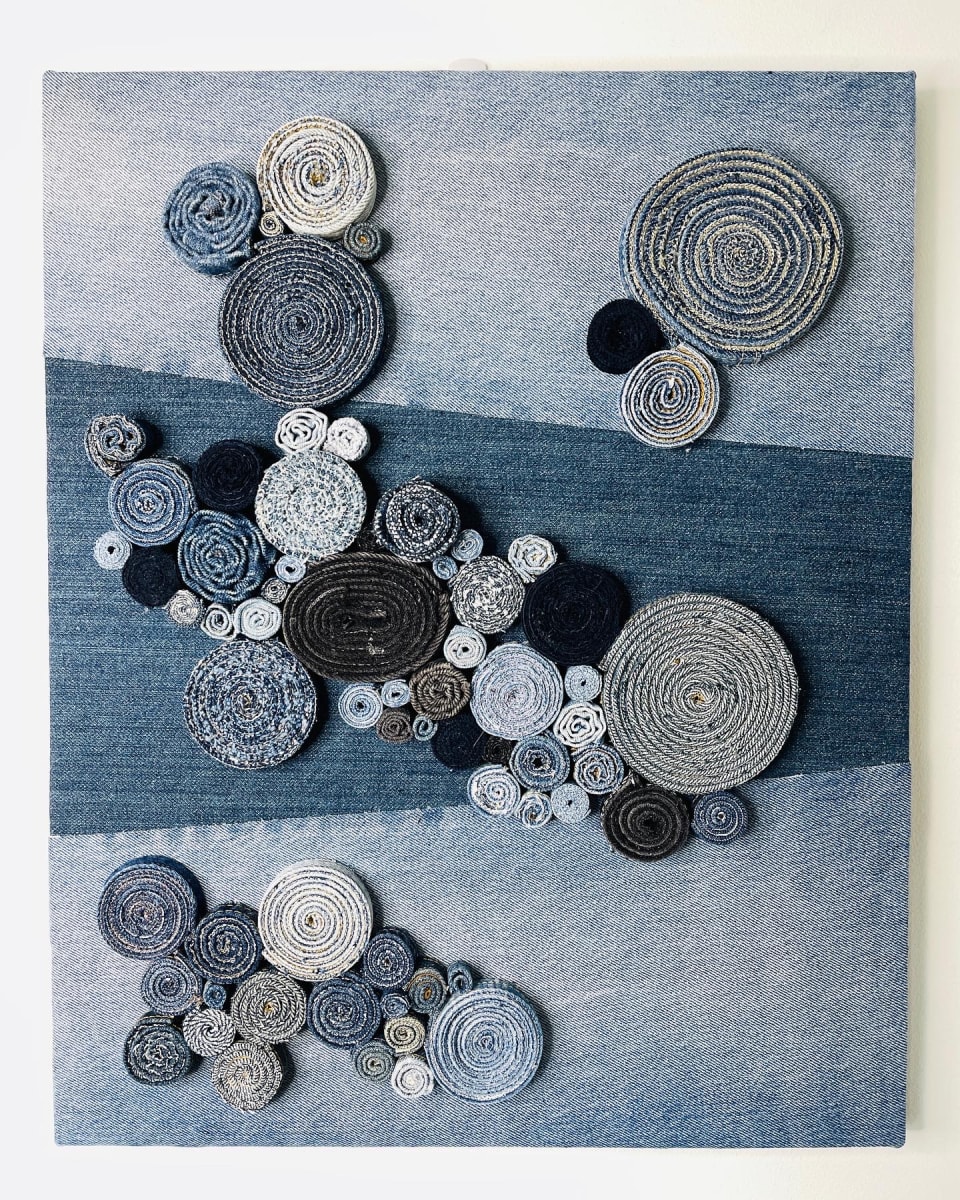 Spirals 1 by Alexandra Jamieson  Image: Upcycled denim spirals on wood panel.  1 of 2 pieces in a diptych.