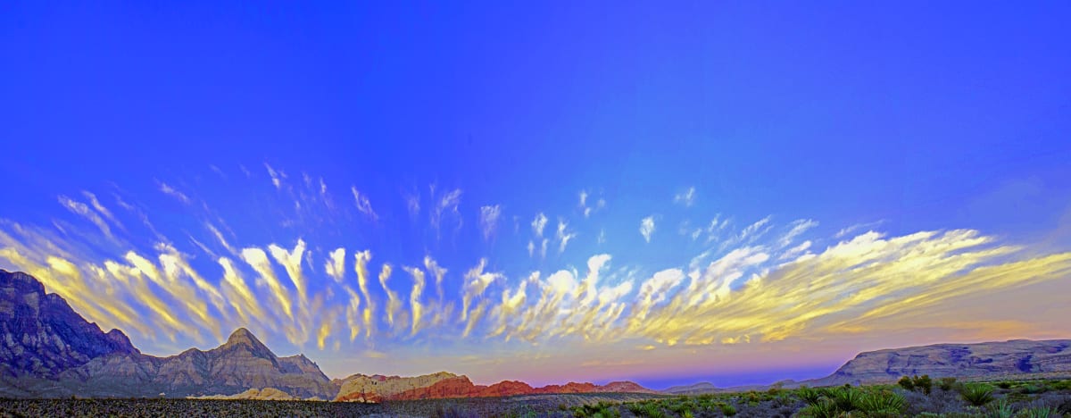 Big Sky by Sandra Swan  Image: Breathtaking sky captured over Red Rock Canyon as a panorama.  When you want to make the finest impression: Acrylic is to wall art, what HD is to TV. Acrylic prints, in basic terms, are photos printed on shatter resistant, lightweight glass panels.

Digital images are printed directly on the surface of the acrylic panel via a flatbed printer creating a luminous look with colors that pop. Acrylic prints are an affordable route to modernize and personalize your decor, giving your residential or commercial space a beautiful focal point that will impress guests and clients alike.

Often found in modern homes/offices, hospitality spaces, and art galleries, this product is truly one-of-a-kind and cannot be replicated by other solutions like a laminated photo, or a photo encased in acrylic for instance. Acrylic offers colors that are more vivid, glossy, and have a higher contrast.

Message for alternative or custom sizes. Also available as conventional print.  