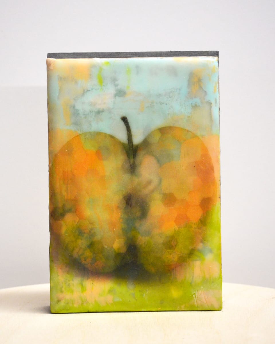 Apple by Kristianne Tefft  Image: This artwork was created by torch fusing clear encaustic medium, various encaustic paints, oil pastels, and pan pastels.  There are also several images burnished into different layers of wax.