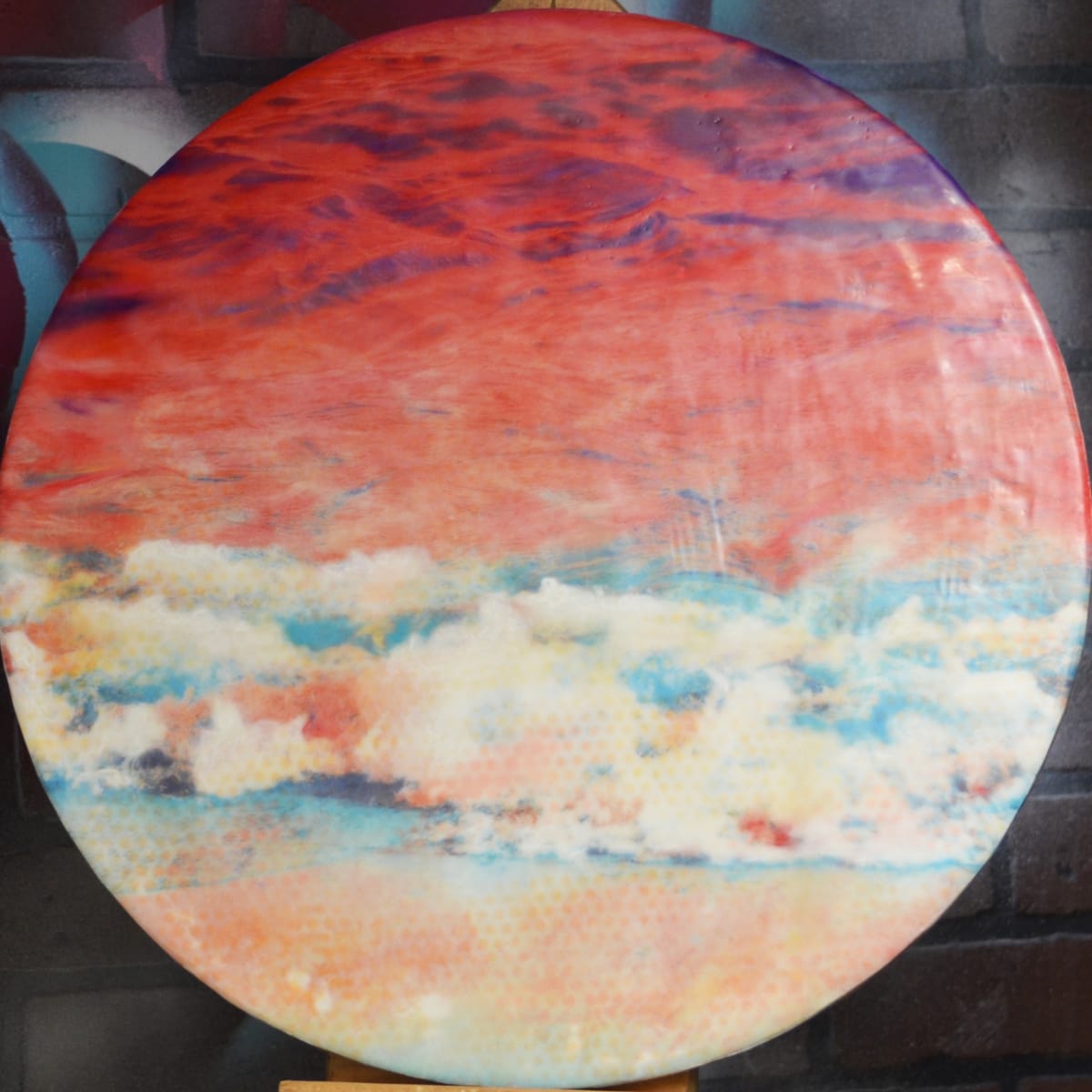 Ben-Day Tide  Image: The rich and bold colors in this piece were inspired by the Ben-Day process of illustration.  This artwork was created by torch fusing clear encaustic medium, white encaustic paint, oil pastels and then burnishing a digitally edited image of a wave crashing against the shore of lake Huron.
