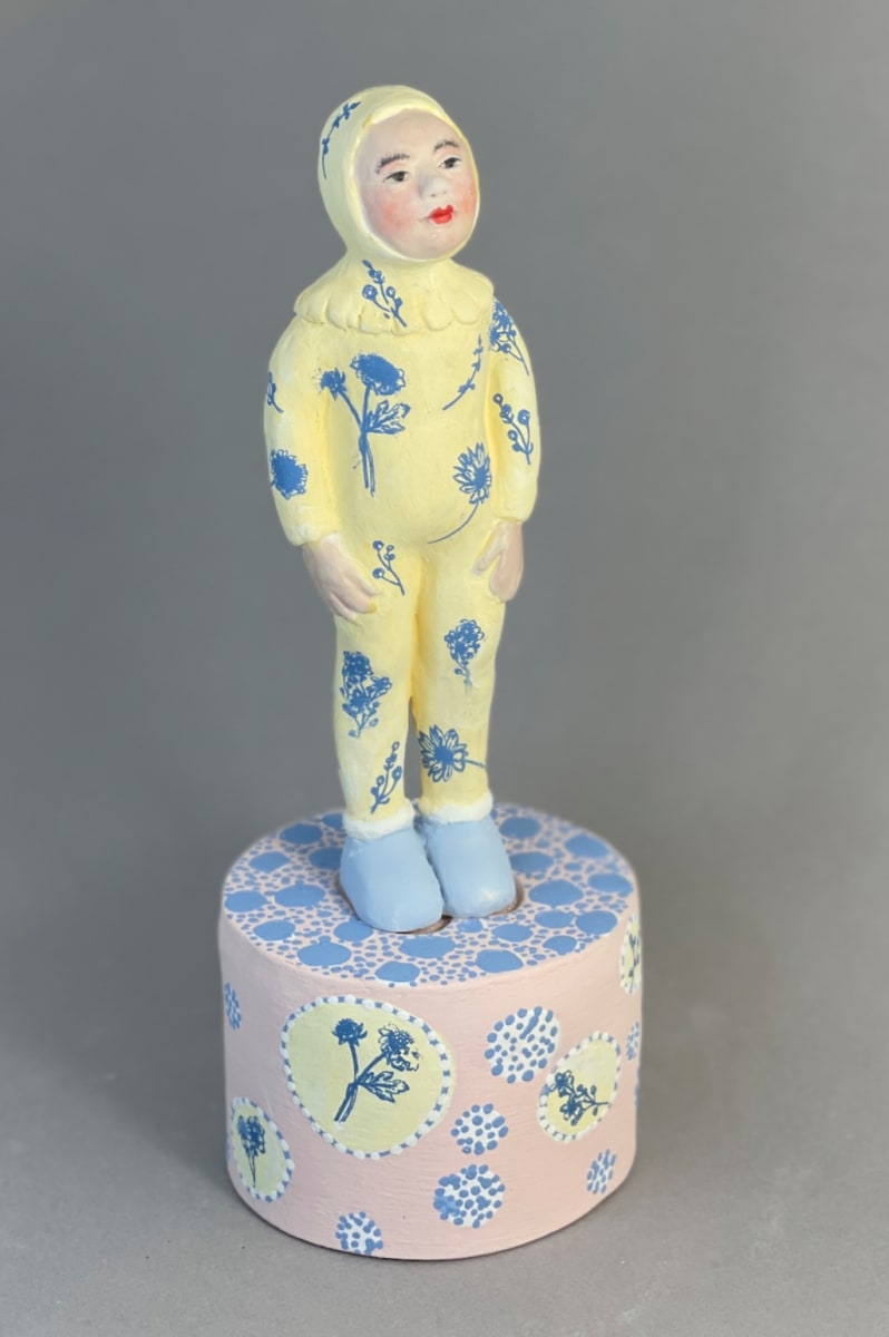 Buttercup by Susan Silvester  Image: Title: Buttercup -
This sculpture combines a bunny outfit with floral accents, evoking a charming blend of nature and childhood. It celebrates the beauty found in simple moments of joy and wonder.