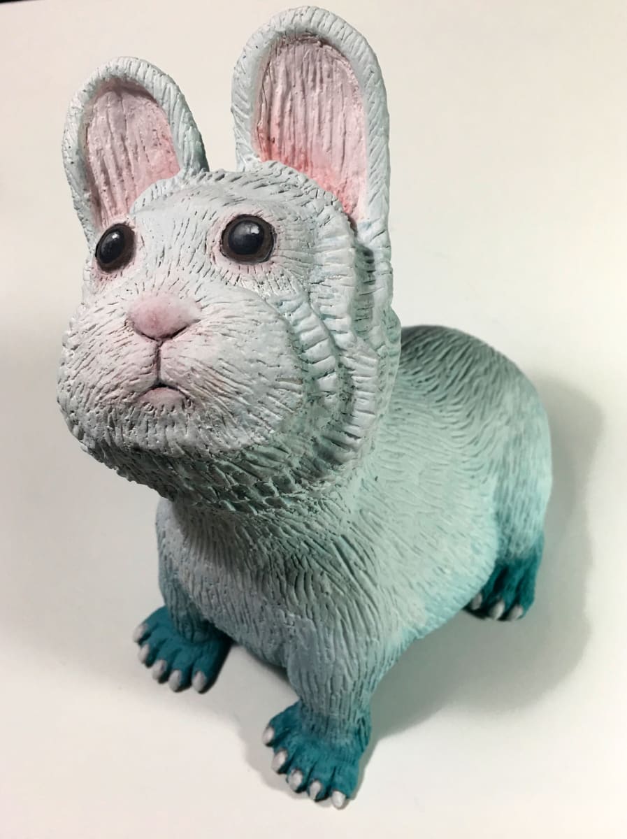 Magical Rabbit by Susan Silvester  Image: 
"The Magical Rabbit" is inspired by the enchanting tales surrounding a rare pika, affectionately known as the magical rabbit in China, embodying the mystique and allure of folklore. This ceramic sculpture captures the essence of these narratives, bringing a piece of mythical charm into the tangible world. Its unique glaze, transitioning from a pastel teal to white with hints of pink, mimics the delicate artistry of a wedding cake, symbolizing celebration and joy. Through this creation, I aim to bridge the gap between the realms of magic and reality, inviting onlookers to delve into the wonders of nature and imagination.