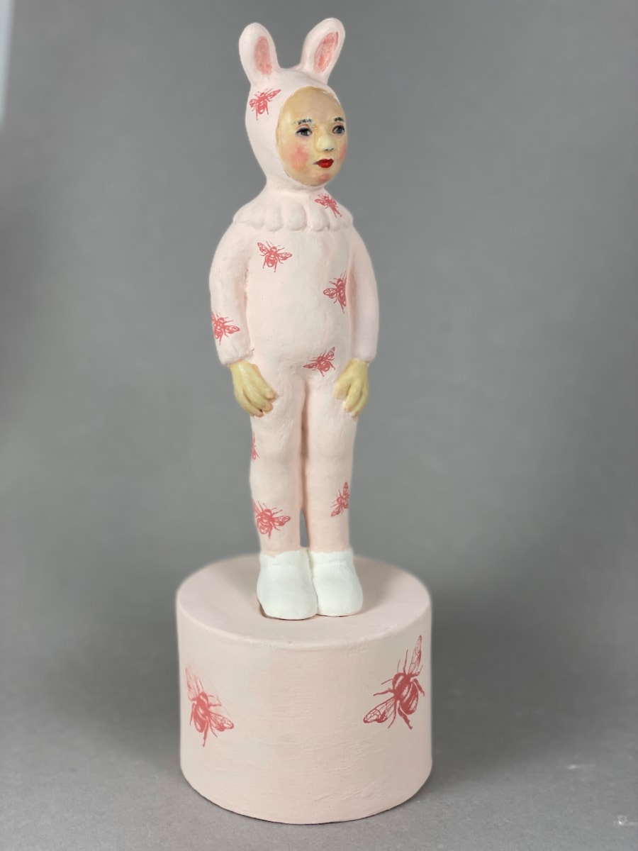 Rosy by Susan Silvester  Image: This sculpture combines a bunny outfit with floral accents, evoking a charming blend of nature and childhood