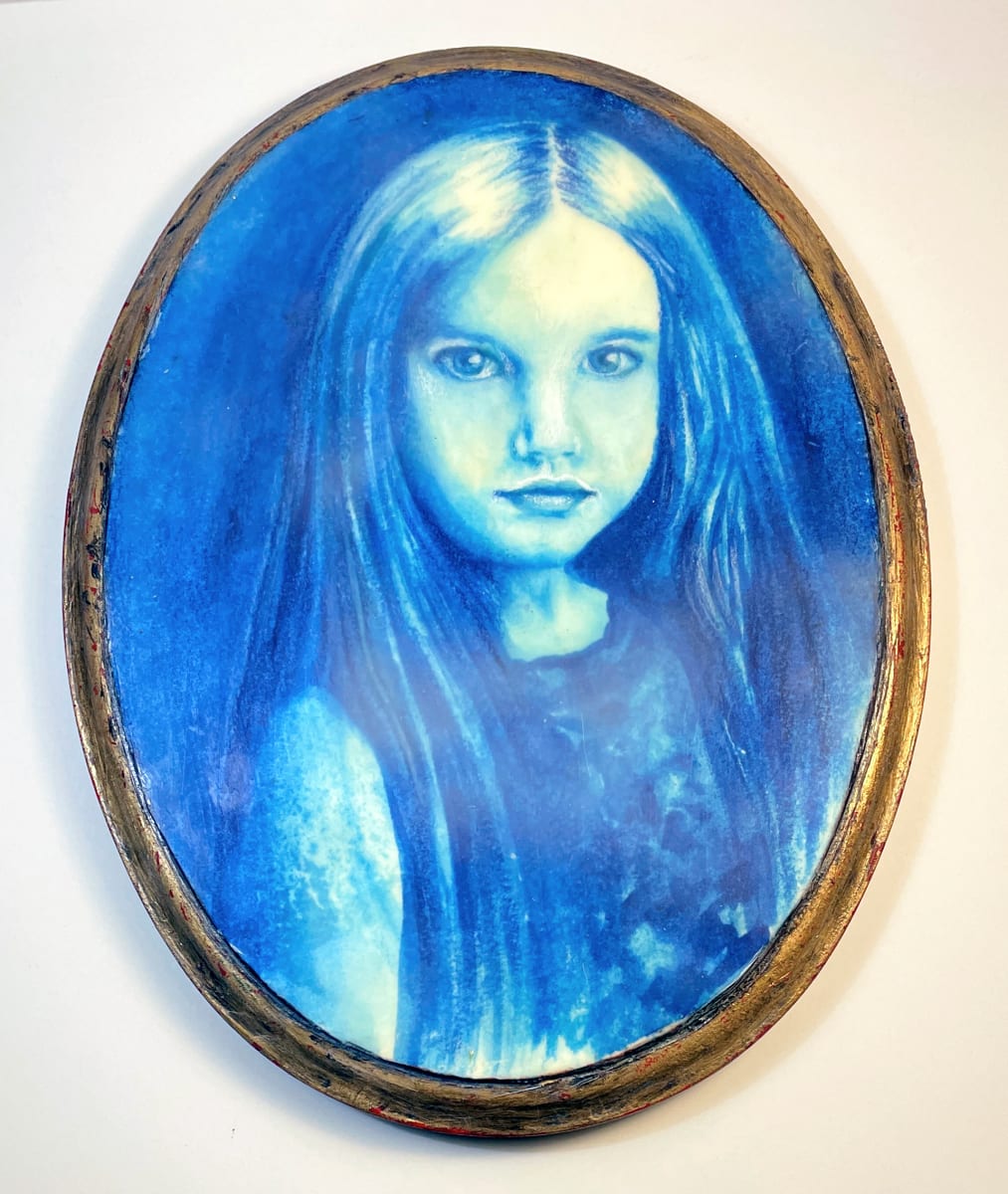 Veiled in Blue by Susan Silvester  Image: "Veiled in Blue" reveals a serene world through a watercolor portrait of a young girl, softly draped in dreamy blue tones. The waxy encaustic layer adds a subtle veil, enhancing the nostalgic aura, while the faux antiqued gold leaf frame frames her gaze, inviting contemplation of the timeless beauty veiled in the innocence of youth
