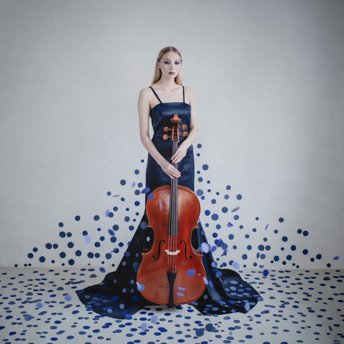 Cello Suite No. 1 in G Major, Prélude – Bach by Dasha Pears  Image: "The spotlight descends on the stage, all eyes resting upon a porcelain woman laced in blue royalty. Confined though she may seem, and as still as a painted cherub, her eyes tell the story of avant-garde balls, of masquerades, of bright lights, of rendezvous backstage.

And then, all at once, she raises her arm. The orchestra falls into silence, and she begins her story. Without words, only strings, does she speak. A tale so scandalous, so enchanting, and so enticing that the audience falls into a trance, captivated by the story she unravels."