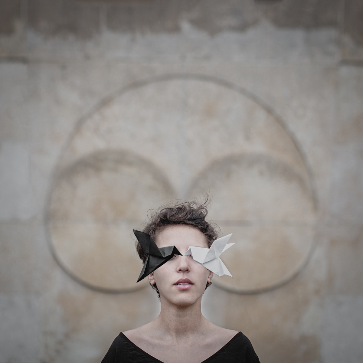 Struggle by Dasha Pears  Image: I became interested in working with origami birds because of their simplicity and symbolism. They are fragile and easy to break, at the same time a bird usually perceived as a symbol of freedom, passion, endurance, and imagination, to say nothing about happiness. That's why I love exploring this symbol in multiple situations and various combinations of locations, colors, models, and shapes. I'm also always fascinated by the topic of the duality of many things in the world. We are able to understand some notions, only because they have opposites, like sound and silence, light and darkness. I don't like to label those opposites as good or bad, I believe that it's all the matter of the perspective of the person who is perceiving them. Often, we are a combination of many opposites and are one in the end.