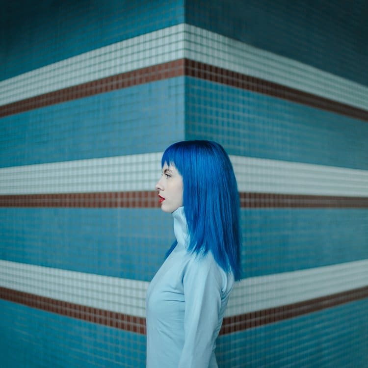 Blues by Dasha Pears  Image: This work came along when I was shooting my Paper Cuts project, focused above all on monochrome, of the color blue in this case. It was shot at a commuter train station in Helsinki, Finland, and takes advantage of the station's unique design. For me, this work is a reminder that simple things around us can look surreal and magical from a certain angle. But often, we forget about the magic of life, whether man-made or created by nature, and simply pass it by. Yet, the magic is always there, we just need to make a slight effort to get conscious of it and see it all around.