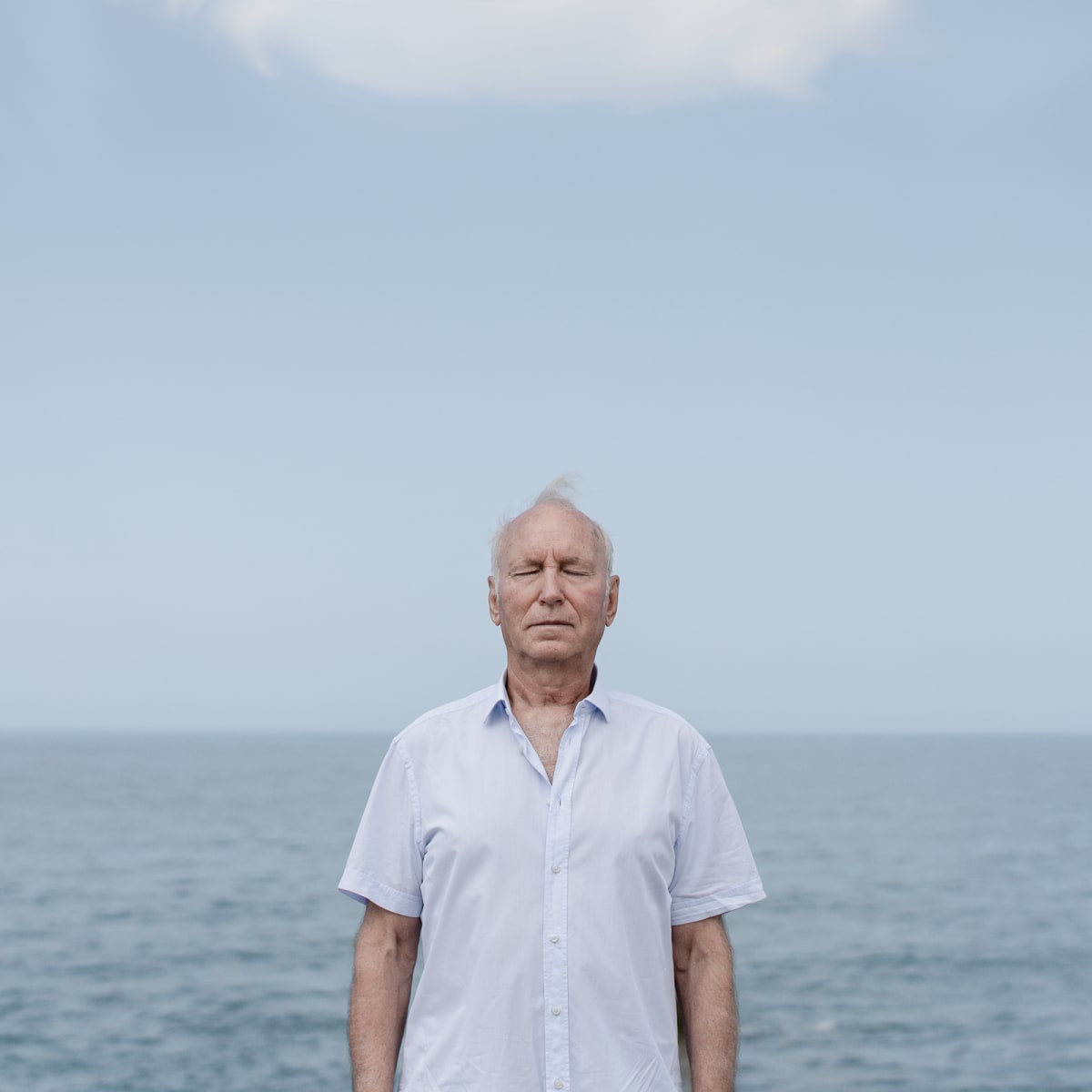 Dad  Image: It was a big decision for me to take portraits of my parents in the first place. Not because “I had to” or they expected me to, but because I wanted to do it, I REALLY felt like it. It suddenly occurred to me that this is how I viewed them (or better sensed, because I wasn’t consciously thinking about them this way ever) t.

Mom has always been full of energy, both productive and distractive. The fast and the furious. She was the “fire” in my life: she could keep me warm, but she could really burn me at times. Saying it in the past tense, because I describe my childhood perspective of things, and frankly, my childhood, the psychological one, lasted for too long. Only now do I feel like finally have grown up and have become disconnected from all the past emotions, traumas, fears, expectations, and hopes that little Dasha had.

My mom is the hero of my life and I really want to state that with this portrait. She’s strong, powerful, fearless. She endured and still does much pain in her life, but that didn’t and doesn’t brake her. She gave me the fuel and the courage to do many things in life, both genetically and by her own example, and for that I’m endlessly grateful.

I really feel that the color and the vertical lines in the background reflect the strength, assertiveness, and energy that I have always seen in her.

My dad has always been a quintessence of calm and emotional control. I never, and I mean NEVER even once, saw him getting angry or bitter about anything in life. He always seemed steady and stable, and even boring and lacking change, and cold sometimes. He could stop any fire and heal any burn with his relaxed coolness.

I didn’t appreciate it much, when growing up, but later in life the stillness that he transferred to me paid off immensely. I wouldn’t be who I am today if I never took a more grounded, cold, calm, and controlled view of life situations I’ve faced. I am hugely grateful to have inherited this part from my father.

I tried to convey the cool and calm stillness of my father’s soul through the horizontal lines, absence of details, and the color palette, which is comprised of various shades of blue and grey.

I almost cried when editing the works. Finally accepting my parents as people, not as gods that they have always seemed to me when I was a child. I didn’t want to make them prettier, I didn’t want to retouch too much. The portraits are about acceptance. They are being themselves and I am accepting them as they are. And accepting myself through this process.