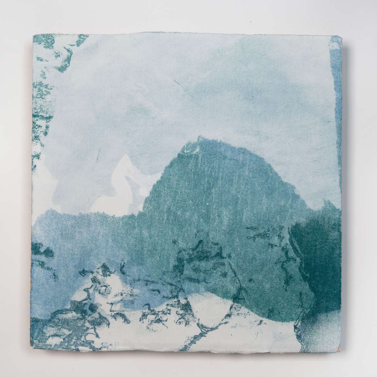 Ice Watch Studies #13 by Megan Broughton  Image: A series of experimental etchings evoking atmospheric Arctic seascapes. These pieces were made in memory of ice watches during the MaréMotrice artist residency in Greenland, sailing through foggy fjords. They function like a brilliant, shapeshifting, reveal through the fog and play with Arctic mirages and cause tricks of the eye. There are moments of clear detail and sublime wonder amidst fragmentation. Two etching plates were printed over each other multiple times in different orientations to create new and abstracted imagery. Stencils made of torn newsprint were used to block ink during the printing process, creating the white shapes throughout the works. The stencils were continually torn apart and reused throughout the series so that the stencil shapes become self-referential but are constantly transforming and deteriorating. Mounted on a cradled wooden panel.
