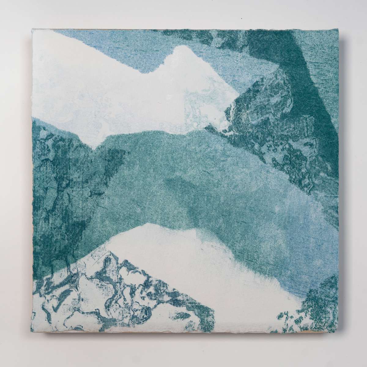 Ice Watch Studies #14 by Megan Broughton  Image: A series of experimental etchings evoking atmospheric Arctic seascapes. These pieces were made in memory of ice watches during the MaréMotrice artist residency in Greenland, sailing through foggy fjords. They function like a brilliant, shapeshifting, reveal through the fog and play with Arctic mirages and cause tricks of the eye. There are moments of clear detail and sublime wonder amidst fragmentation. Two etching plates were printed over each other multiple times in different orientations to create new and abstracted imagery. Stencils made of torn newsprint were used to block ink during the printing process, creating the white shapes throughout the works. The stencils were continually torn apart and reused throughout the series so that the stencil shapes become self-referential but are constantly transforming and deteriorating. Mounted on a cradled wooden panel.