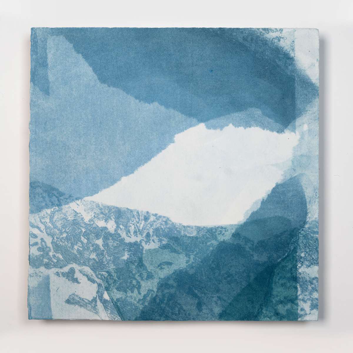 Ice Watch Studies #18 by Megan Broughton  Image: A series of experimental etchings evoking atmospheric Arctic seascapes. These pieces were made in memory of ice watches during the MaréMotrice artist residency in Greenland, sailing through foggy fjords. They function like a brilliant, shapeshifting, reveal through the fog and play with Arctic mirages and cause tricks of the eye. There are moments of clear detail and sublime wonder amidst fragmentation. Two etching plates were printed over each other multiple times in different orientations to create new and abstracted imagery. Stencils made of torn newsprint were used to block ink during the printing process, creating the white shapes throughout the works. The stencils were continually torn apart and reused throughout the series so that the stencil shapes become self-referential but are constantly transforming and deteriorating. Mounted on a cradled wooden panel.