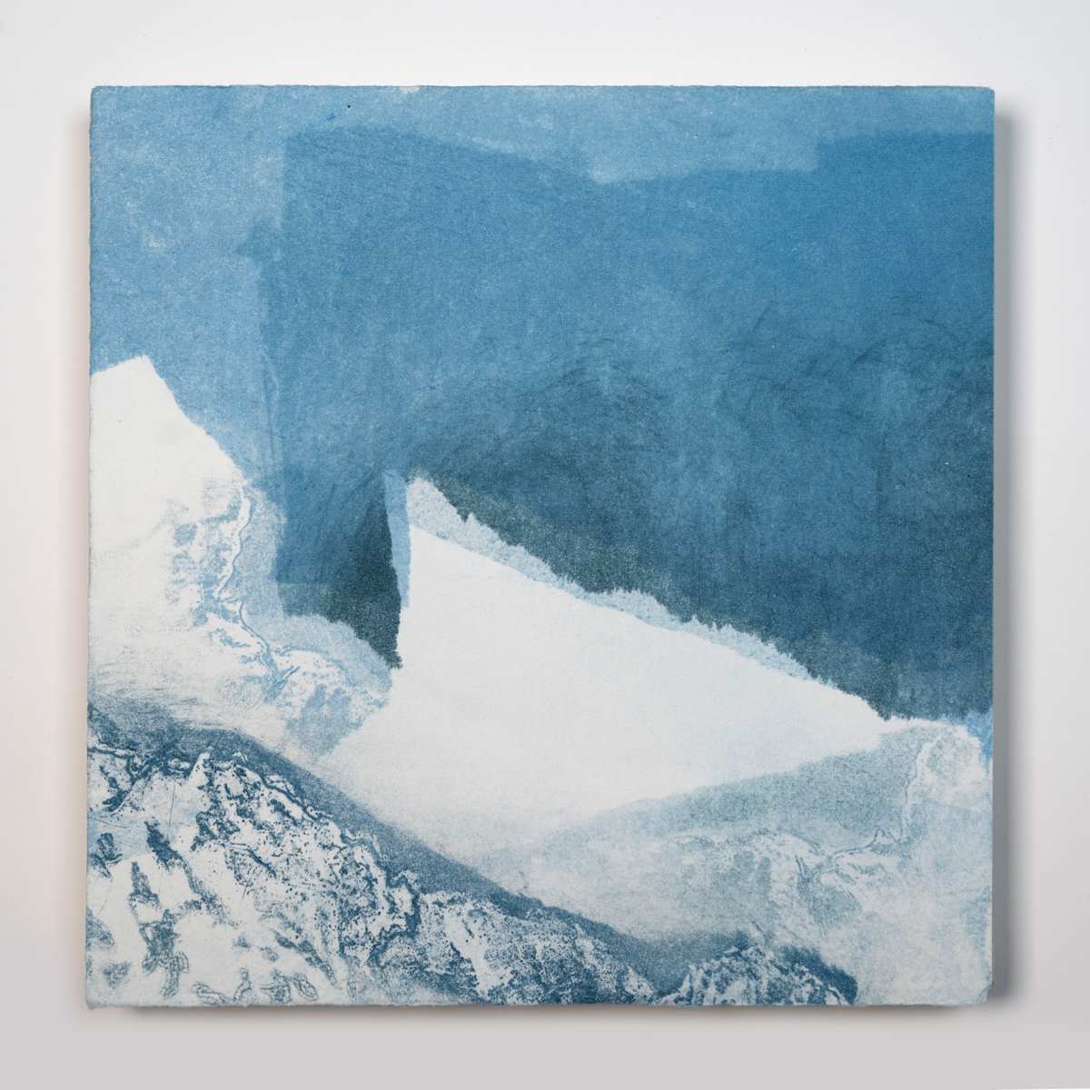 Ice Watch Studies #1 by Megan Broughton  Image: A series of experimental etchings evoking atmospheric Arctic seascapes. These pieces were made in memory of ice watches during the MaréMotrice artist residency in Greenland, sailing through foggy fjords. They function like a brilliant, shapeshifting, reveal through the fog and play with Arctic mirages and cause tricks of the eye. There are moments of clear detail and sublime wonder amidst fragmentation. Two etching plates were printed over each other multiple times in different orientations to create new and abstracted imagery. Stencils made of torn newsprint were used to block ink during the printing process, creating the white shapes throughout the works. The stencils were continually torn apart and reused throughout the series so that the stencil shapes become self-referential but are constantly transforming and deteriorating. Mounted on a cradled wooden panel.