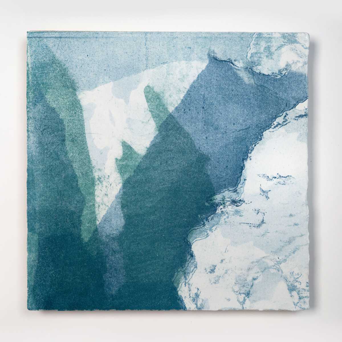 Ice Watch Studies #25 by Megan Broughton  Image: A series of experimental etchings evoking atmospheric Arctic seascapes. These pieces were made in memory of ice watches during the MaréMotrice artist residency in Greenland, sailing through foggy fjords. They function like a brilliant, shapeshifting, reveal through the fog and play with Arctic mirages and cause tricks of the eye. There are moments of clear detail and sublime wonder amidst fragmentation. Two etching plates were printed over each other multiple times in different orientations to create new and abstracted imagery. Stencils made of torn newsprint were used to block ink during the printing process, creating the white shapes throughout the works. The stencils were continually torn apart and reused throughout the series so that the stencil shapes become self-referential but are constantly transforming and deteriorating. Mounted on a cradled wooden panel.