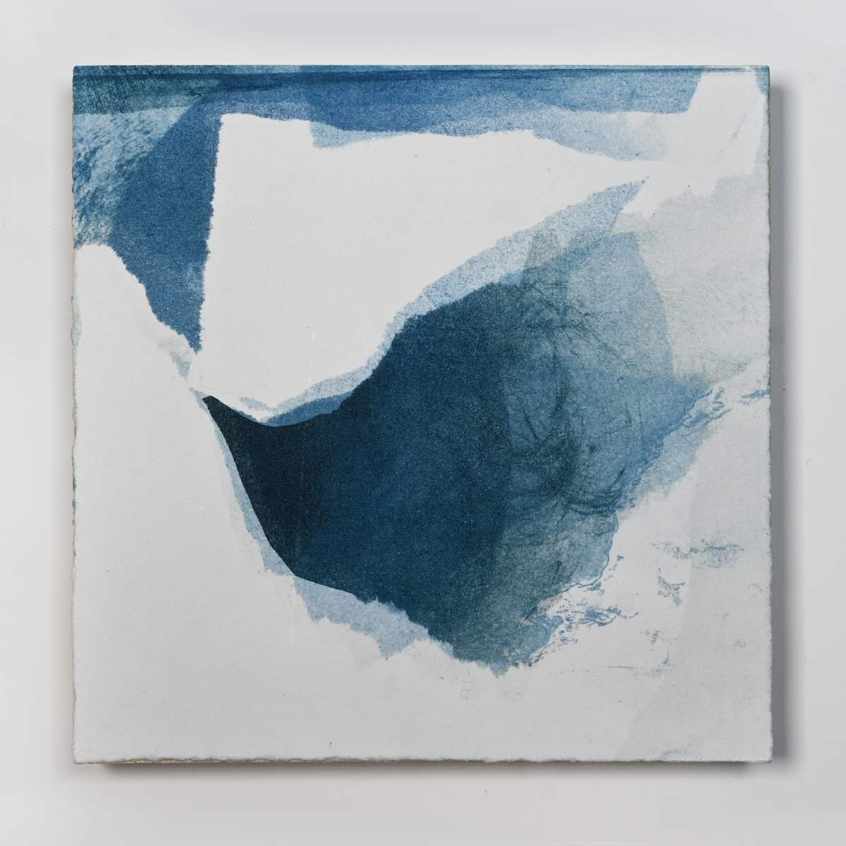Ice Watch Studies #26 by Megan Broughton  Image: A series of experimental etchings evoking atmospheric Arctic seascapes. These pieces were made in memory of ice watches during the MaréMotrice artist residency in Greenland, sailing through foggy fjords. They function like a brilliant, shapeshifting, reveal through the fog and play with Arctic mirages and cause tricks of the eye. There are moments of clear detail and sublime wonder amidst fragmentation. Two etching plates were printed over each other multiple times in different orientations to create new and abstracted imagery. Stencils made of torn newsprint were used to block ink during the printing process, creating the white shapes throughout the works. The stencils were continually torn apart and reused throughout the series so that the stencil shapes become self-referential but are constantly transforming and deteriorating. Mounted on a cradled wooden panel.
