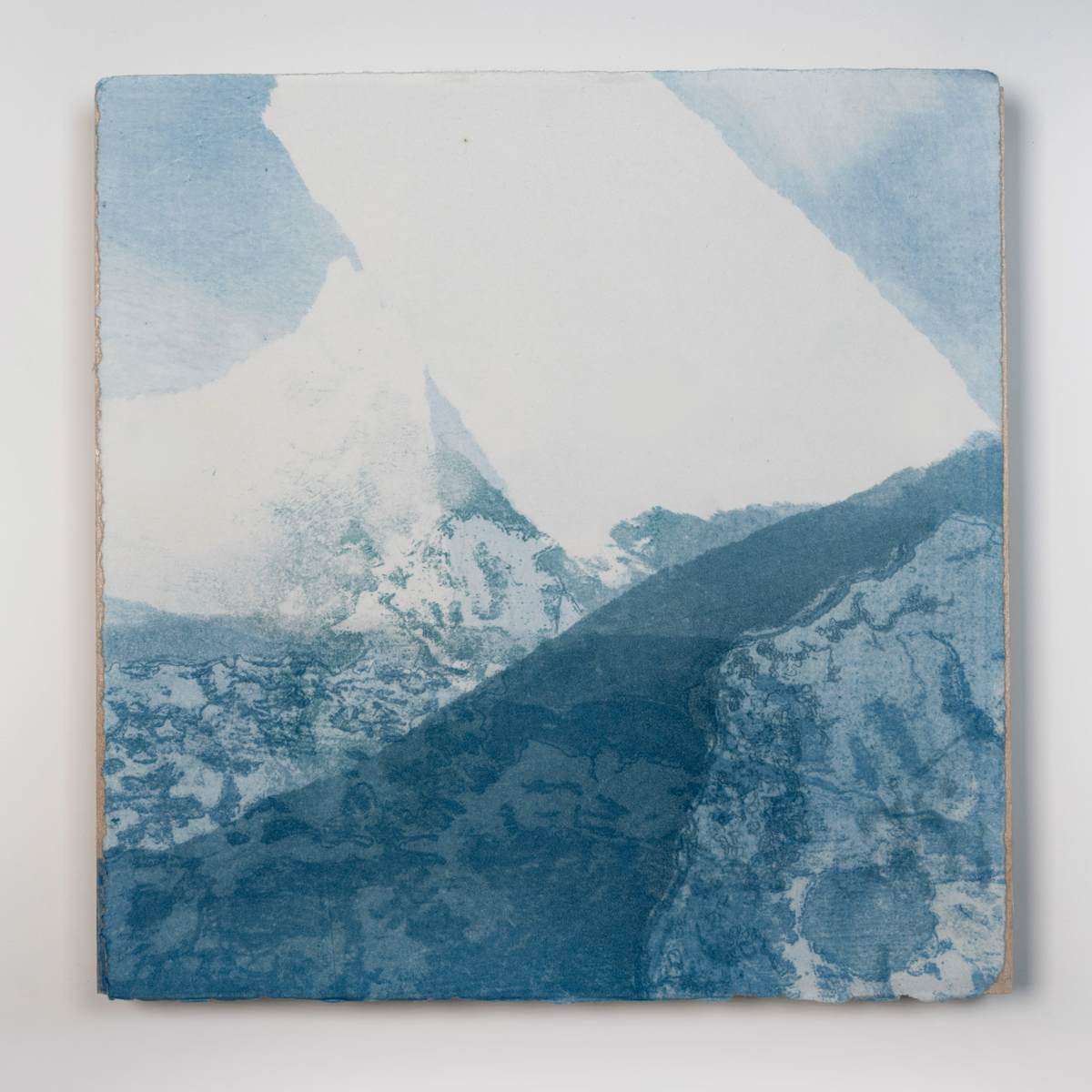 Ice Watch Studies #2 by Megan Broughton  Image: A series of experimental etchings evoking atmospheric Arctic seascapes. These pieces were made in memory of ice watches during the MaréMotrice artist residency in Greenland, sailing through foggy fjords. They function like a brilliant, shapeshifting, reveal through the fog and play with Arctic mirages and cause tricks of the eye. There are moments of clear detail and sublime wonder amidst fragmentation. Two etching plates were printed over each other multiple times in different orientations to create new and abstracted imagery. Stencils made of torn newsprint were used to block ink during the printing process, creating the white shapes throughout the works. The stencils were continually torn apart and reused throughout the series so that the stencil shapes become self-referential but are constantly transforming and deteriorating. Mounted on a cradled wooden panel.