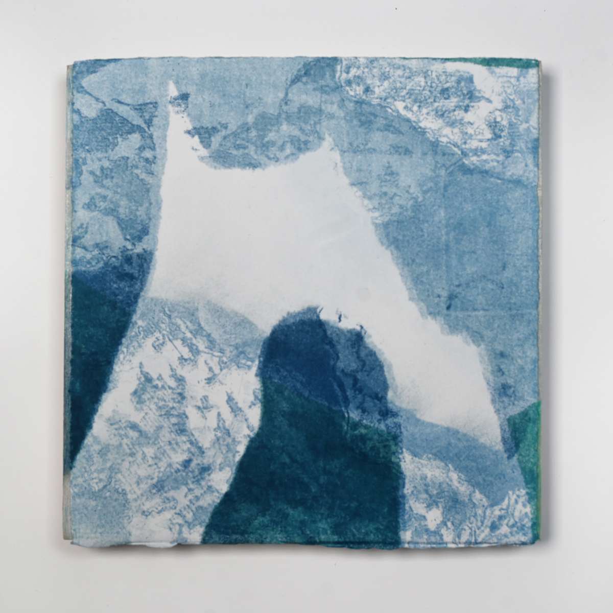 Ice Watch Studies #38 by Megan Broughton  Image: A series of experimental etchings evoking atmospheric Arctic seascapes. These pieces were made in memory of ice watches during the MaréMotrice artist residency in Greenland, sailing through foggy fjords. They function like a brilliant, shapeshifting, reveal through the fog and play with Arctic mirages and cause tricks of the eye. There are moments of clear detail and sublime wonder amidst fragmentation. Two etching plates were printed over each other multiple times in different orientations to create new and abstracted imagery. Stencils made of torn newsprint were used to block ink during the printing process, creating the white shapes throughout the works. The stencils were continually torn apart and reused throughout the series so that the stencil shapes become self-referential but are constantly transforming and deteriorating. Mounted on a cradled wooden panel.