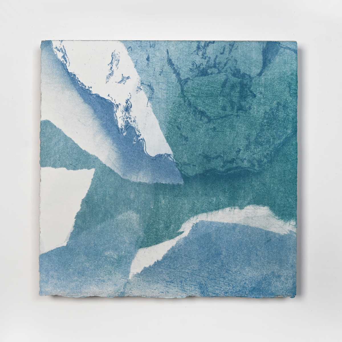 Ice Watch Studies #40 by Megan Broughton  Image: A series of experimental etchings evoking atmospheric Arctic seascapes. These pieces were made in memory of ice watches during the MaréMotrice artist residency in Greenland, sailing through foggy fjords. They function like a brilliant, shapeshifting, reveal through the fog and play with Arctic mirages and cause tricks of the eye. There are moments of clear detail and sublime wonder amidst fragmentation. Two etching plates were printed over each other multiple times in different orientations to create new and abstracted imagery. Stencils made of torn newsprint were used to block ink during the printing process, creating the white shapes throughout the works. The stencils were continually torn apart and reused throughout the series so that the stencil shapes become self-referential but are constantly transforming and deteriorating. Mounted on a cradled wooden panel.