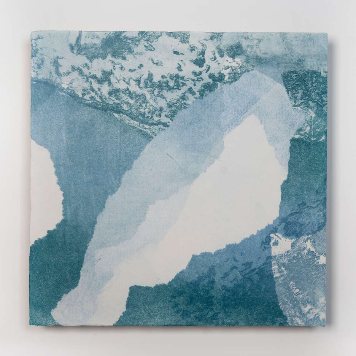 Ice Watch Studies #4 by Megan Broughton  Image: A series of experimental etchings evoking atmospheric Arctic seascapes. These pieces were made in memory of ice watches during the MaréMotrice artist residency in Greenland, sailing through foggy fjords. They function like a brilliant, shapeshifting, reveal through the fog and play with Arctic mirages and cause tricks of the eye. There are moments of clear detail and sublime wonder amidst fragmentation. Two etching plates were printed over each other multiple times in different orientations to create new and abstracted imagery. Stencils made of torn newsprint were used to block ink during the printing process, creating the white shapes throughout the works. The stencils were continually torn apart and reused throughout the series so that the stencil shapes become self-referential but are constantly transforming and deteriorating. Mounted on a cradled wooden panel.