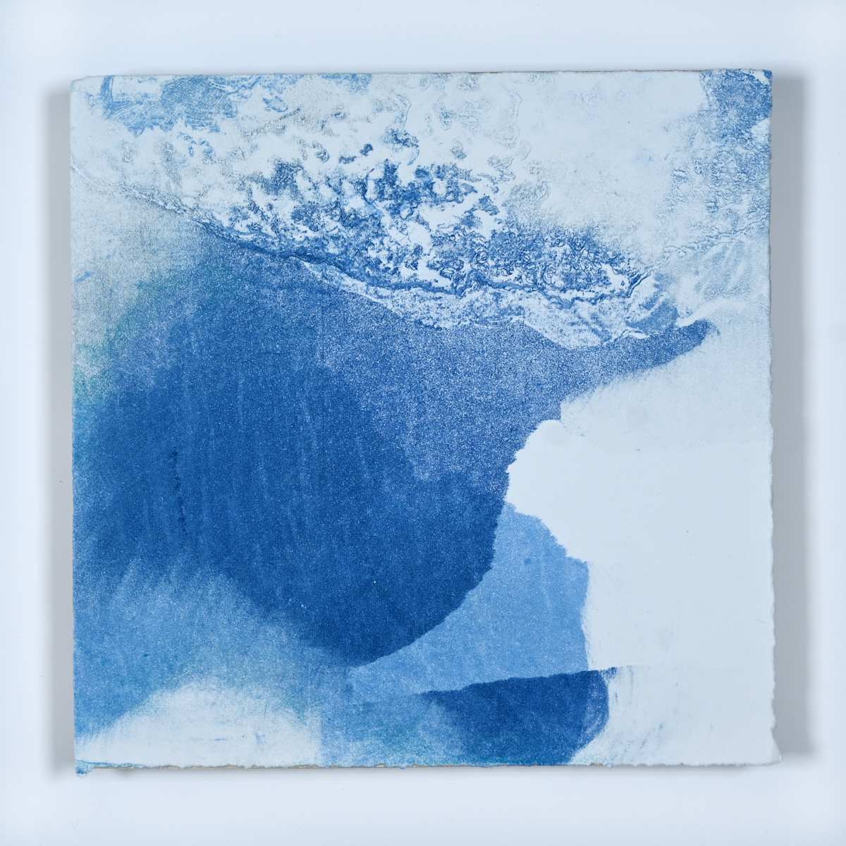 Ice Watch Studies #64 by Megan Broughton  Image: A series of experimental etchings evoking atmospheric Arctic seascapes. These pieces were made in memory of ice watches during the MaréMotrice artist residency in Greenland, sailing through foggy fjords. They function like a brilliant, shapeshifting, reveal through the fog and play with Arctic mirages and cause tricks of the eye. There are moments of clear detail and sublime wonder amidst fragmentation. Two etching plates were printed over each other multiple times in different orientations to create new and abstracted imagery. Stencils made of torn newsprint were used to block ink during the printing process, creating the white shapes throughout the works. The stencils were continually torn apart and reused throughout the series so that the stencil shapes become self-referential but are constantly transforming and deteriorating.