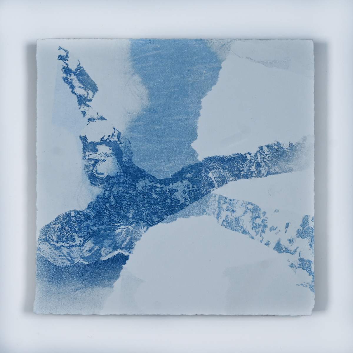 Ice Watch Studies #67 by Megan Broughton  Image: A series of experimental etchings evoking atmospheric Arctic seascapes. These pieces were made in memory of ice watches during the MaréMotrice artist residency in Greenland, sailing through foggy fjords. They function like a brilliant, shapeshifting, reveal through the fog and play with Arctic mirages and cause tricks of the eye. There are moments of clear detail and sublime wonder amidst fragmentation. Two etching plates were printed over each other multiple times in different orientations to create new and abstracted imagery. Stencils made of torn newsprint were used to block ink during the printing process, creating the white shapes throughout the works. The stencils were continually torn apart and reused throughout the series so that the stencil shapes become self-referential but are constantly transforming and deteriorating.