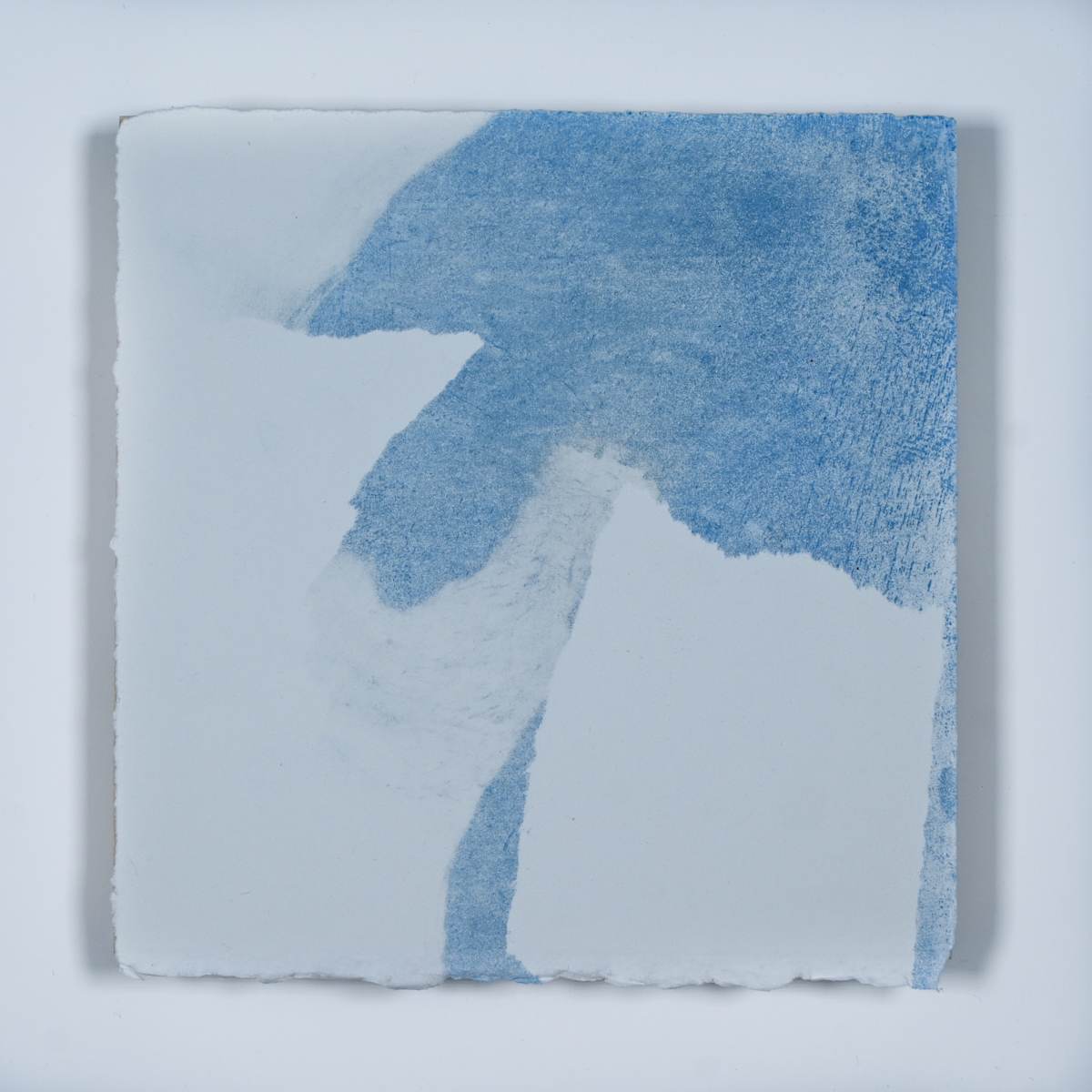 Ice Watch Studies #72 by Megan Broughton  Image: A series of experimental etchings evoking atmospheric Arctic seascapes. These pieces were made in memory of ice watches during the MaréMotrice artist residency in Greenland, sailing through foggy fjords. They function like a brilliant, shapeshifting, reveal through the fog and play with Arctic mirages and cause tricks of the eye. There are moments of clear detail and sublime wonder amidst fragmentation. Two etching plates were printed over each other multiple times in different orientations to create new and abstracted imagery. Stencils made of torn newsprint were used to block ink during the printing process, creating the white shapes throughout the works. The stencils were continually torn apart and reused throughout the series so that the stencil shapes become self-referential but are constantly transforming and deteriorating.