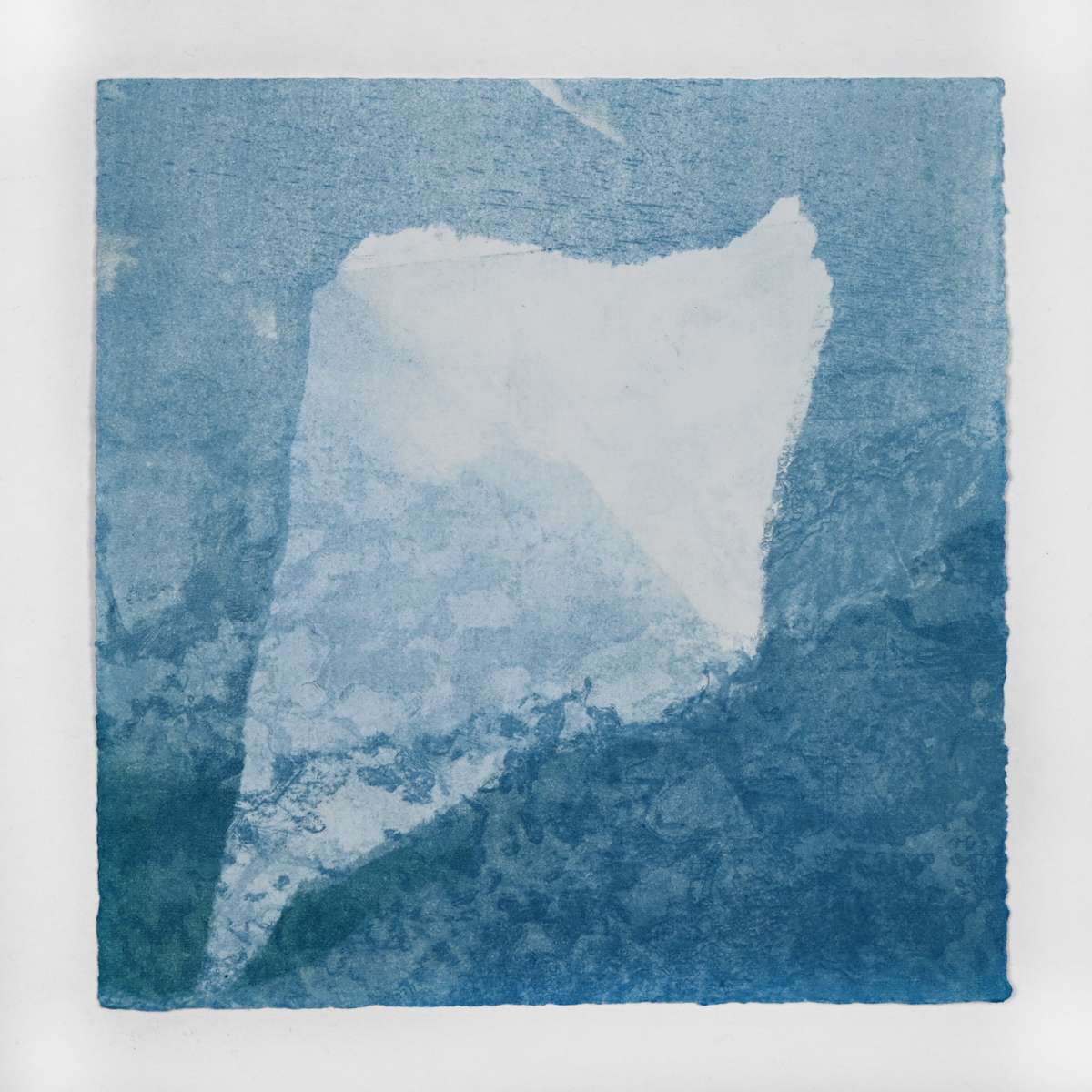 Ice Watch Studies #55 by Megan Broughton  Image: A series of experimental etchings evoking atmospheric Arctic seascapes. These pieces were made in memory of ice watches during the MaréMotrice artist residency in Greenland, sailing through foggy fjords. They function like a brilliant, shapeshifting, reveal through the fog and play with Arctic mirages and cause tricks of the eye. There are moments of clear detail and sublime wonder amidst fragmentation. Two etching plates were printed over each other multiple times in different orientations to create new and abstracted imagery. Stencils made of torn newsprint were used to block ink during the printing process, creating the white shapes throughout the works. The stencils were continually torn apart and reused throughout the series so that the stencil shapes become self-referential but are constantly transforming and deteriorating. 