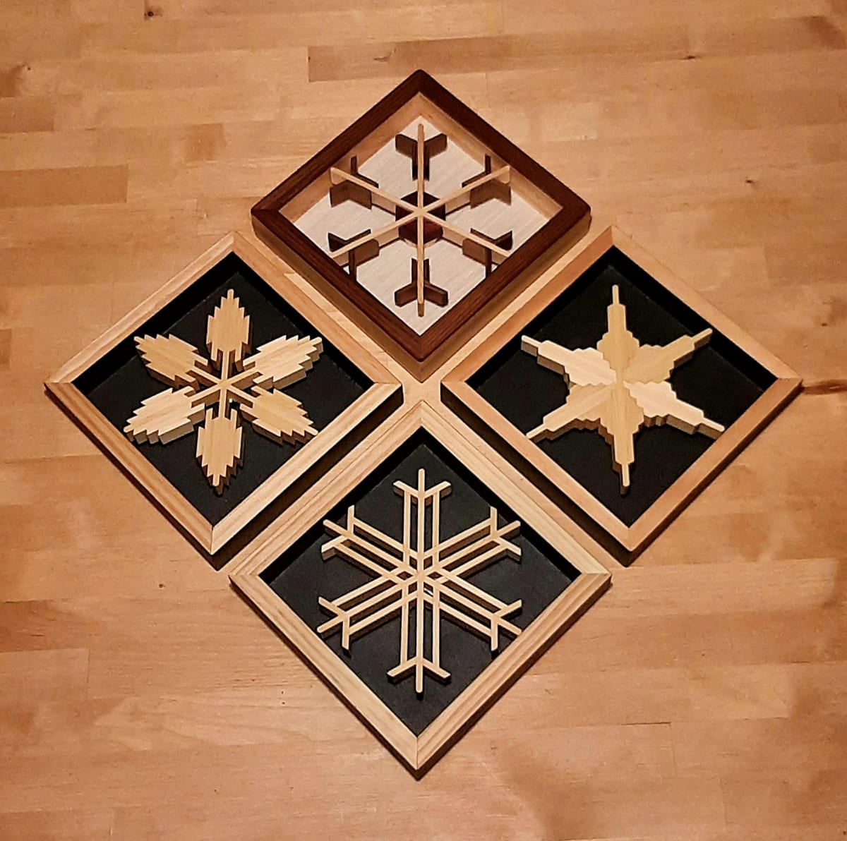 Individual 8"x8" Diamond Framed Snowflakes by Robert E LeBlanc  Image: Birch shadow frames, either flat black to highlight white snowflakes, or various options to highlight multi-coloured flakes.