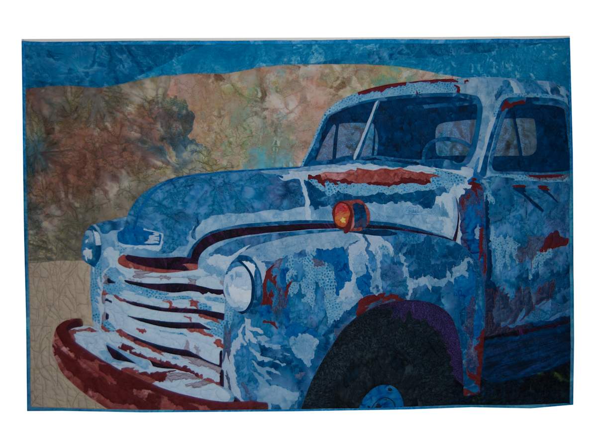 Old Blue by Michelle Jackson  Image: "Old Blue" depicts an abandoned truck, left to age under the New Mexico sun. It captures the essence of what once was, now standing as a testament to time, marked by rust and peeling paint.

I believe this piece truly encapsulates a unique beauty in the passage of time and the stories that inanimate objects can tell.