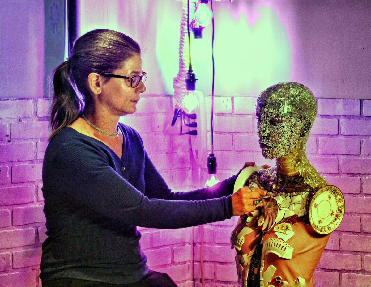 Self Portrait by Emily Stevens  Image: This photograph is of me working on my mosaic self portrait. This photograph was featured in the "Reframing Recovery" exhibit at VisArts in 2022.