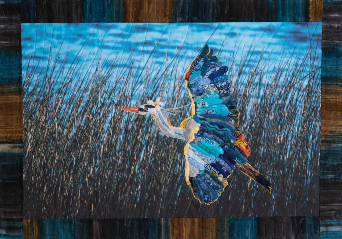 Patient Hunter by Bill Meek and Denny Peterson  Image: For many people, the Great Blue Heron represents patience and good luck, especially for success at fishing. This heron at Arizona’s Luna Lake certainly demonstrated patience, persistence, and success while fishing. This quilt won Honorable Mention in Teravarna's 10th ANIMAL International Juried Art Competition 2025.  