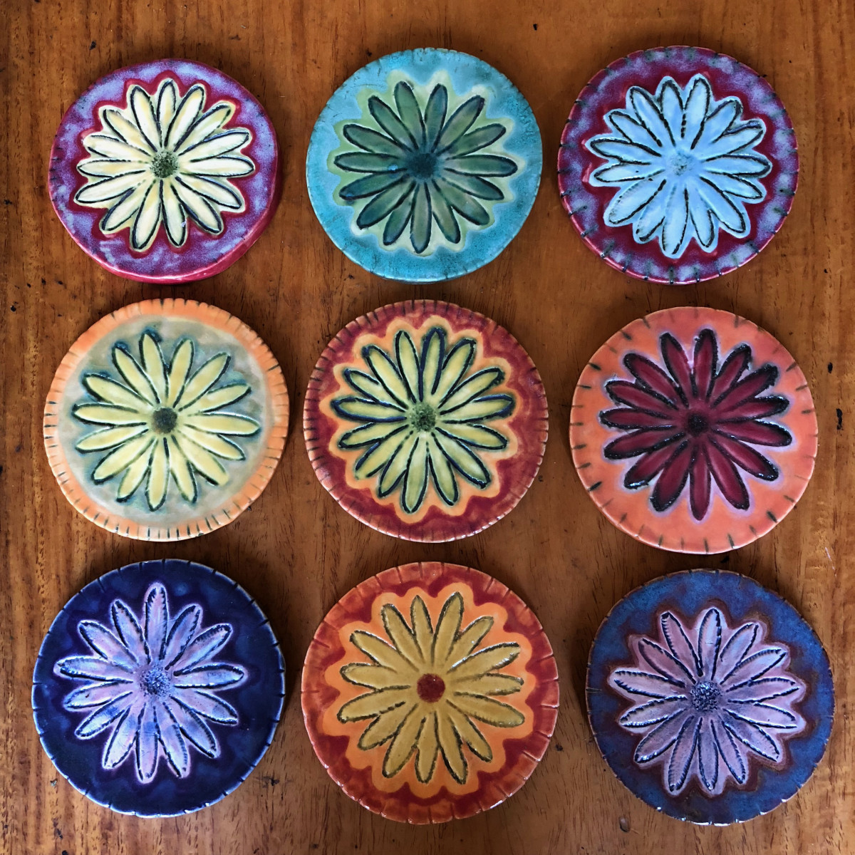 Daisy coasters, lots of colors by Nell Eakin 