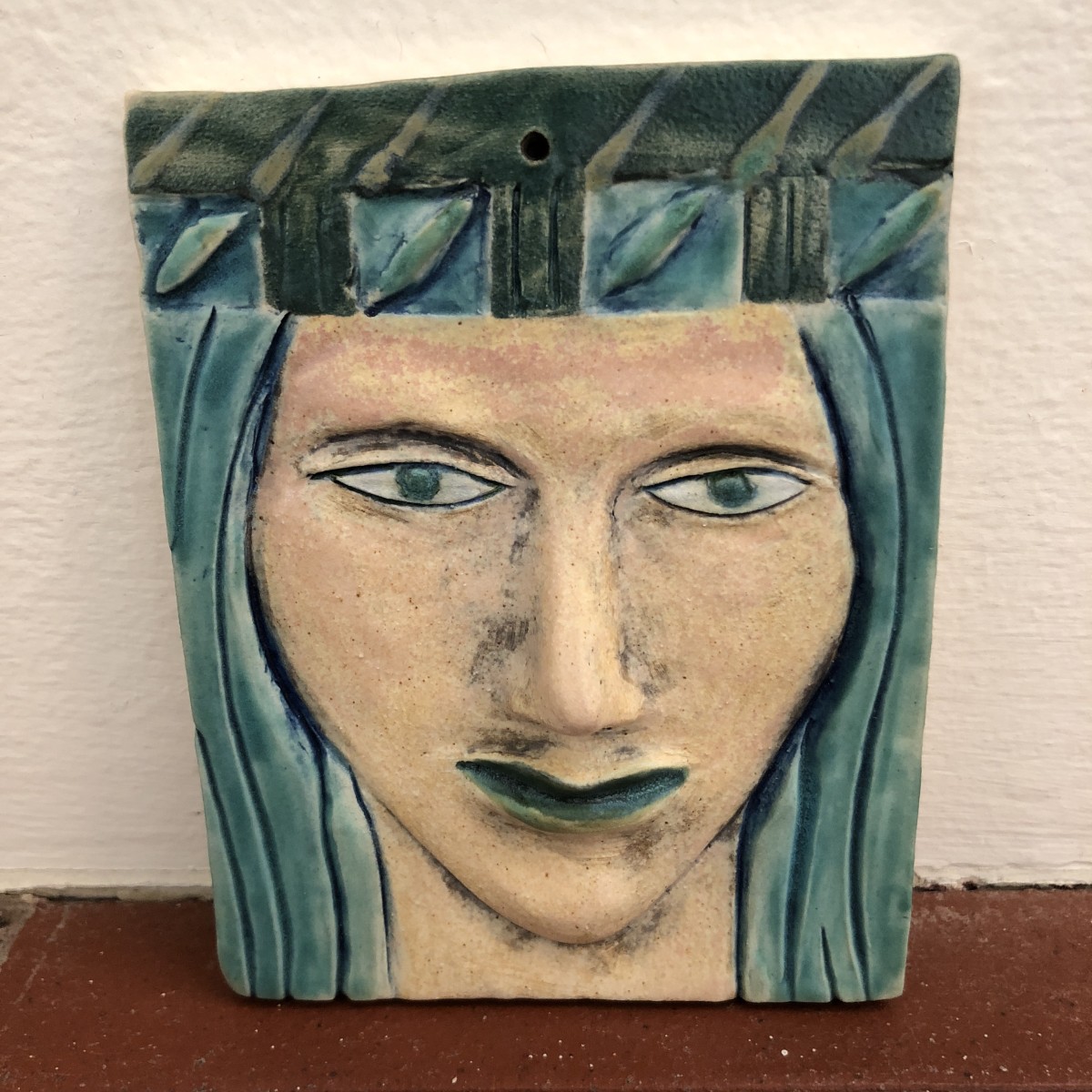 Turquena, a blue haired woman wall hanging woman, with hat by Nell Eakin 