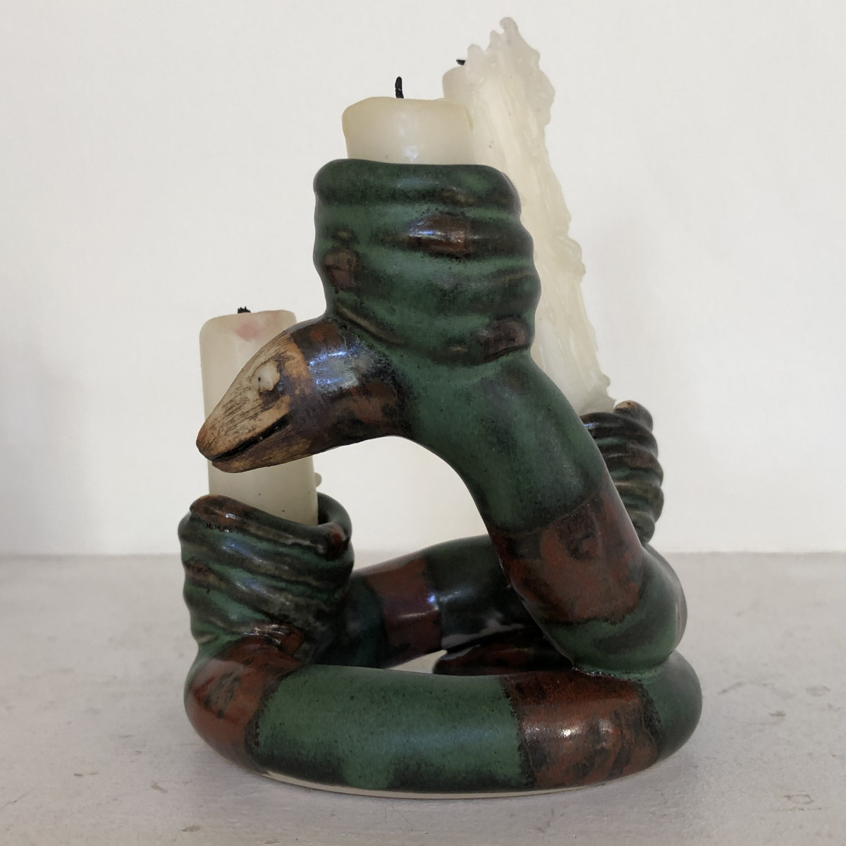 Ela, a mama snake with 3 baby snake candle holders,  is a Snake-a-labra. by Nell Eakin 